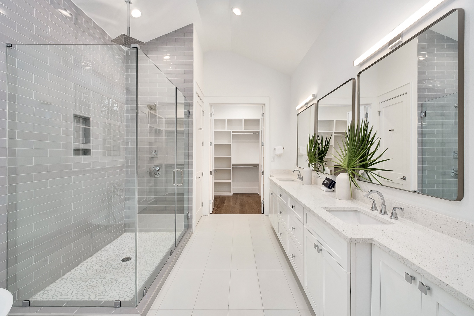 Step into your luxurious ensuite with elegant marble counters, spacious glass shower, and thoughtful storage for your comfort.
