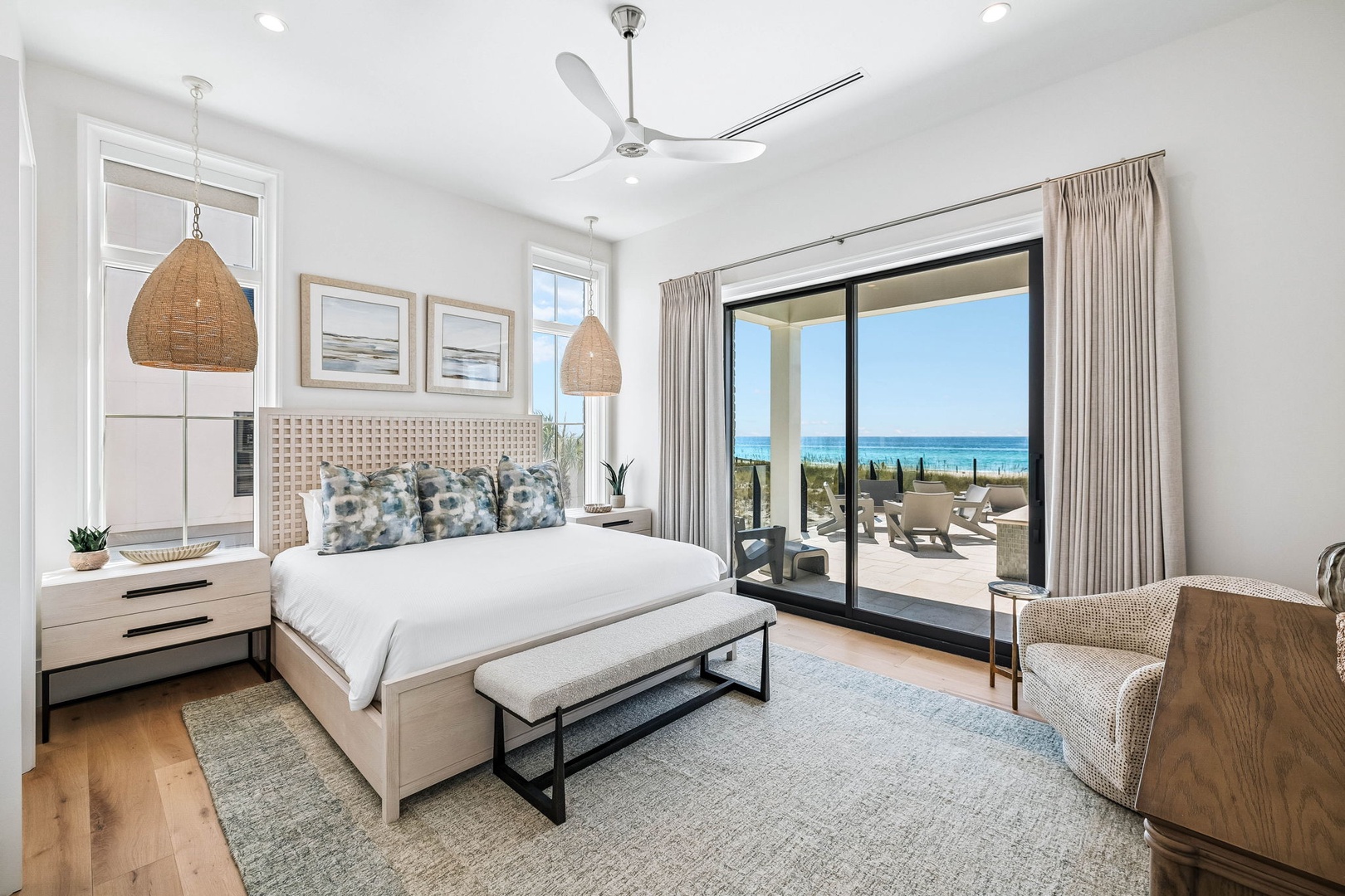 Wake up to stunning ocean views from your serene coastal bedroom, where natural textures and soothing tones create your perfect beach retreat. Step onto your private terrace and breathe in the salt air.
