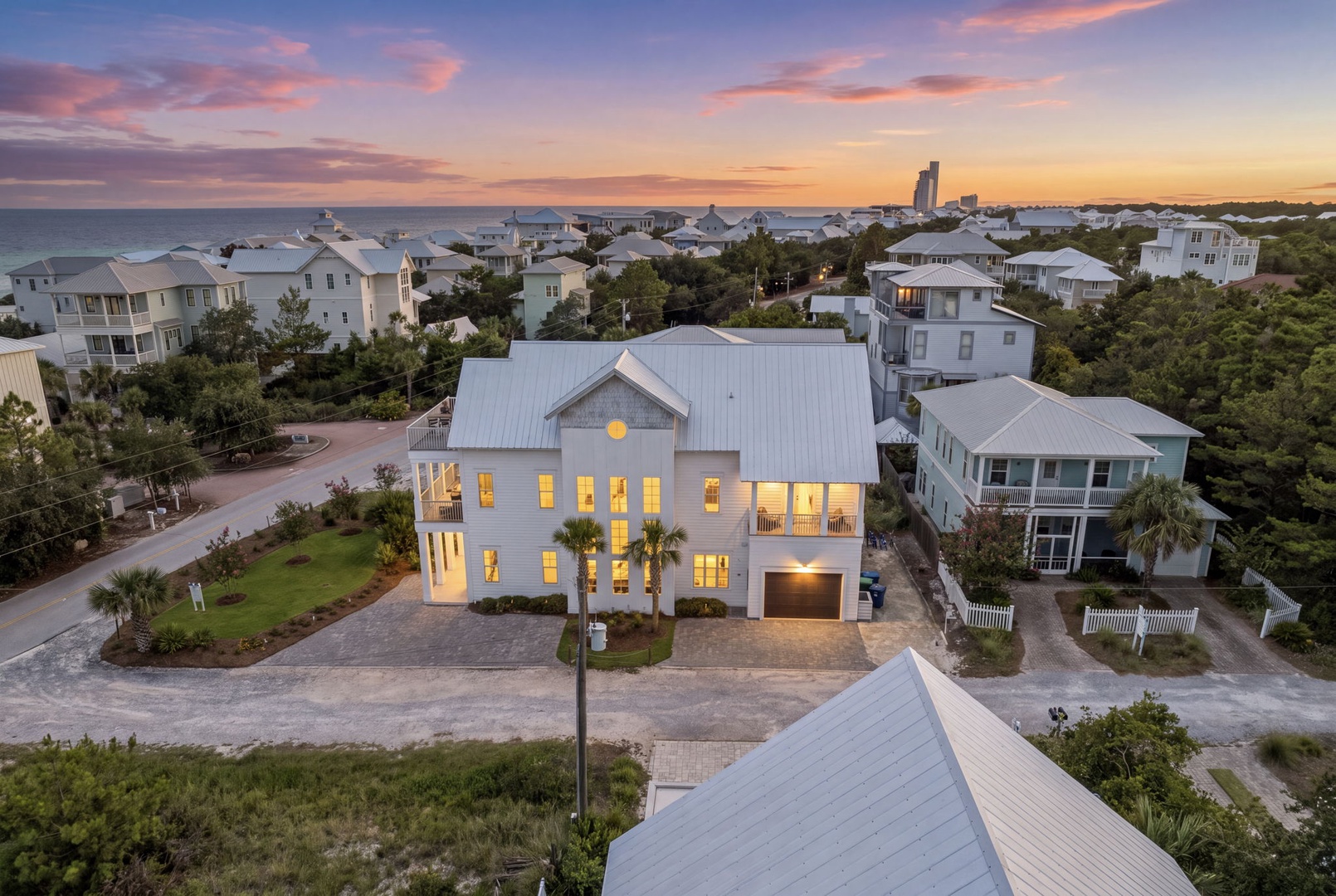 A stunning coastal escape nestled in a peaceful neighborhood, moments from the beach and bathed in the glow of a breathtaking sunset sky.