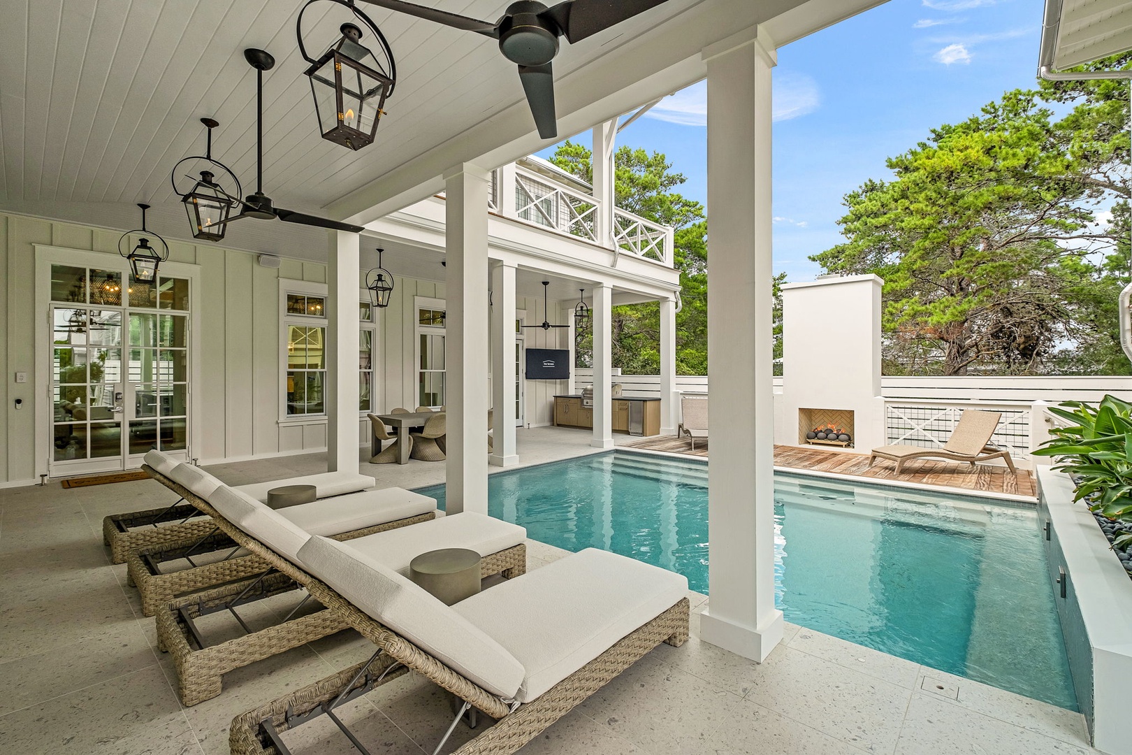 Your private poolside oasis awaits under a ceiling fan and classic lanterns—lounges perfectly placed to soak up the day or enjoy a cool dip steps away.