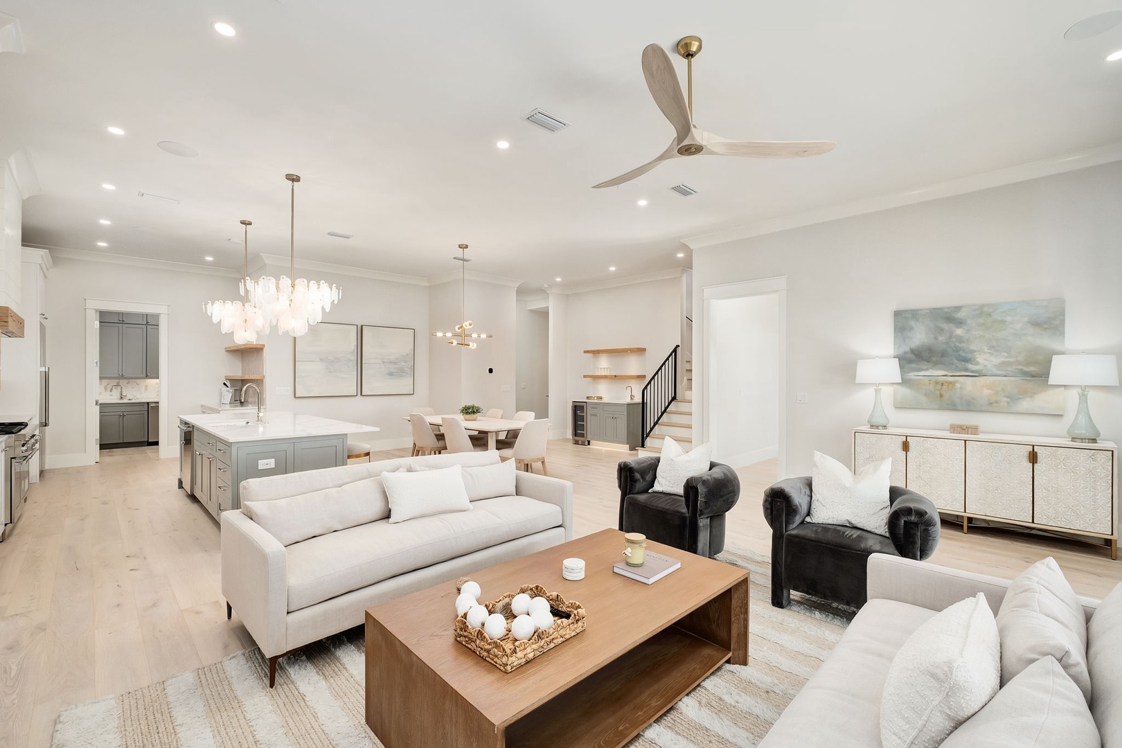 Relax in your stylish open-plan living space with plush seating, elegant lighting, and a gourmet kitchen perfect for entertaining.