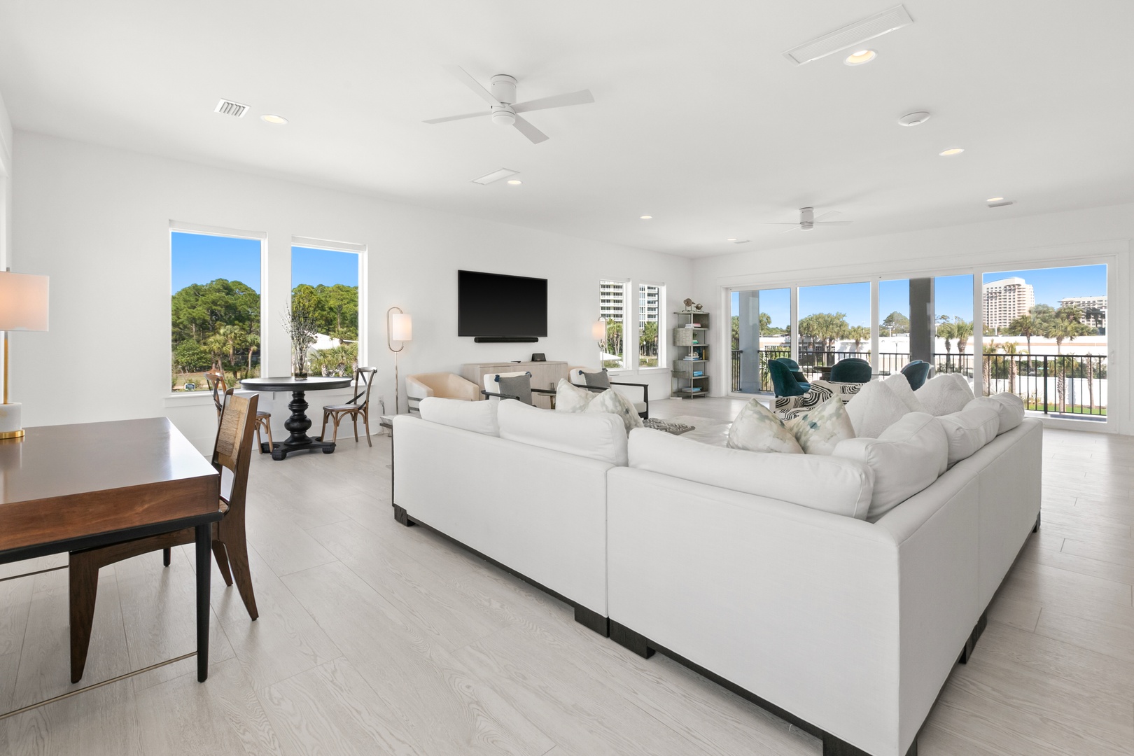 Sink into plush seating and unwind with your favorite show in this bright, airy living space. Natural light pours through multiple windows while the open layout invites effortless conversation and relaxation.