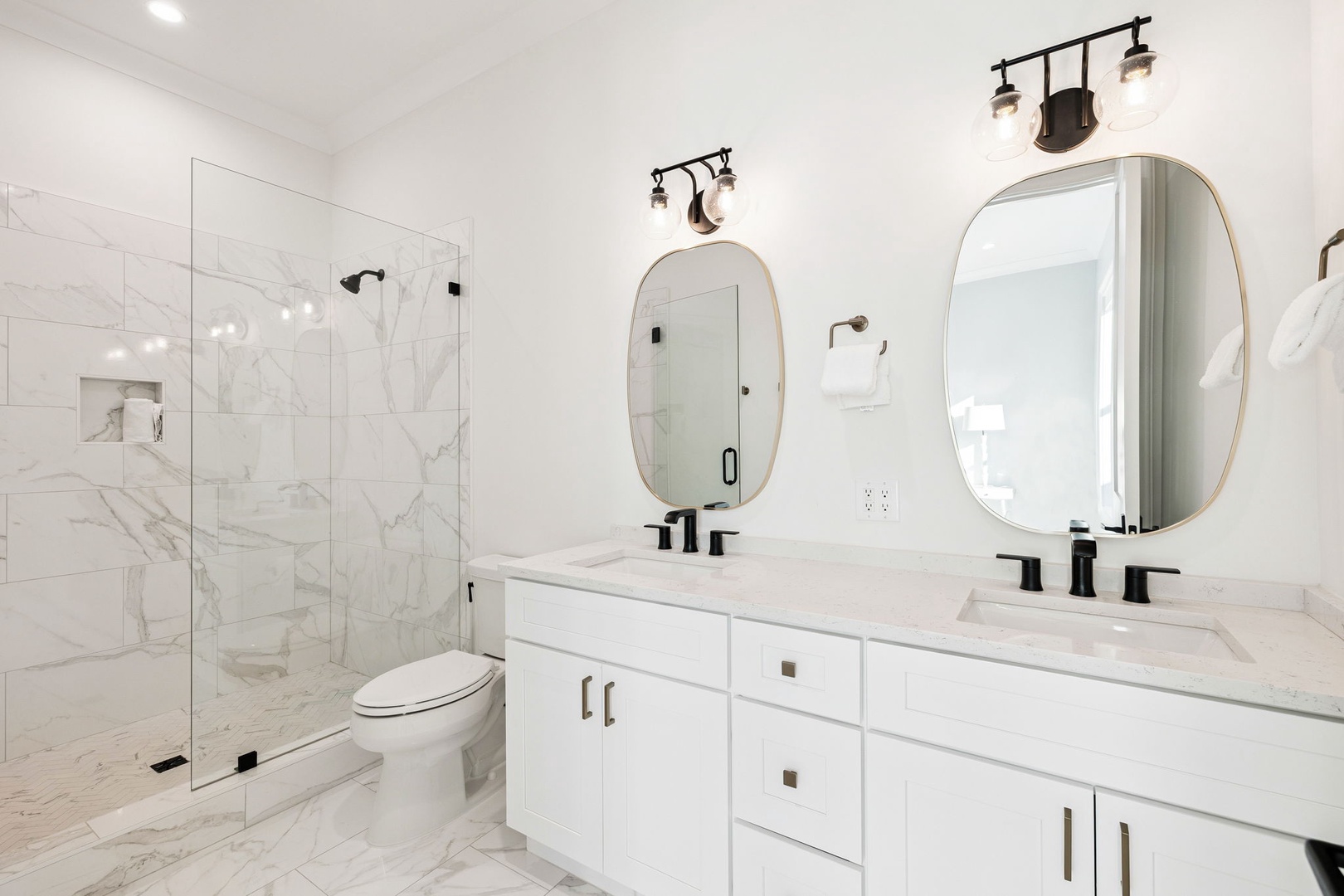 Step into your luxurious marble bathroom with dual vanities, rainfall shower, and elegant lighting for a spa-like morning routine.