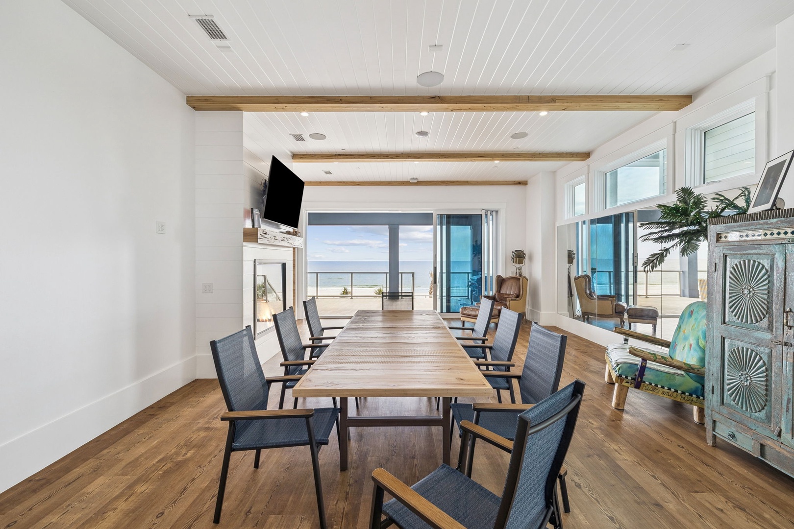 Gather around this stunning dining table where exposed beams frame your ocean view meals and cherished moments with loved ones.