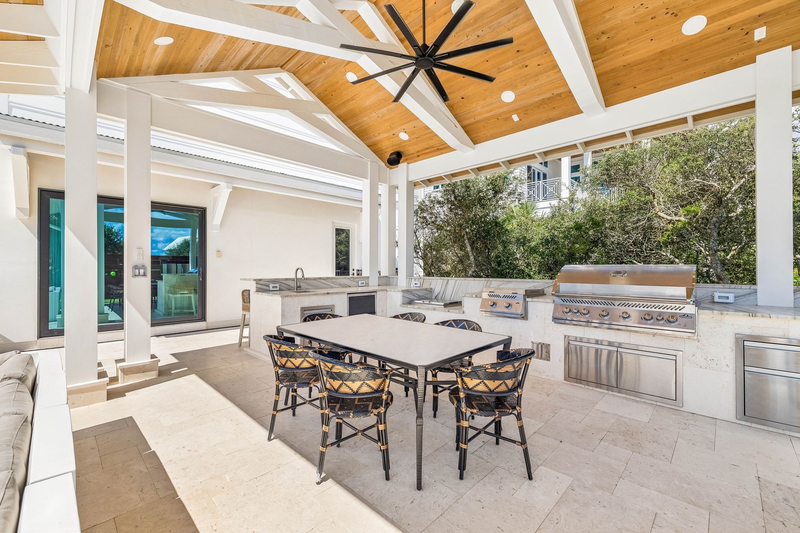 Gather with family and friends in your expansive outdoor kitchen, where vaulted wood ceilings and top-tier grills make every meal an occasion beneath Florida skies.