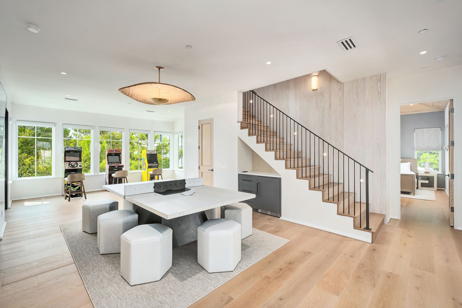 Settle into your light-filled living space where modern design meets effortless comfort. Large windows frame leafy views, while sleek furnishings and warm wood floors create an inviting atmosphere for relaxing and gathering with loved ones.