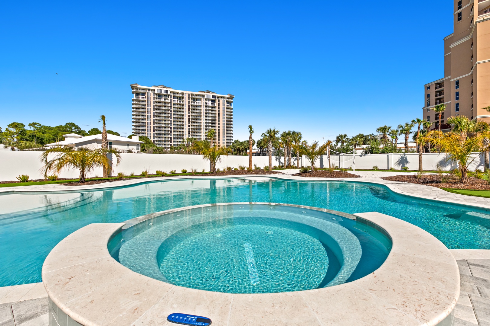 Your resort-style oasis awaits. Dive into the sparkling pool, unwind in the integrated hot tub, and soak in the sunshine beneath swaying palms and clear blue skies.