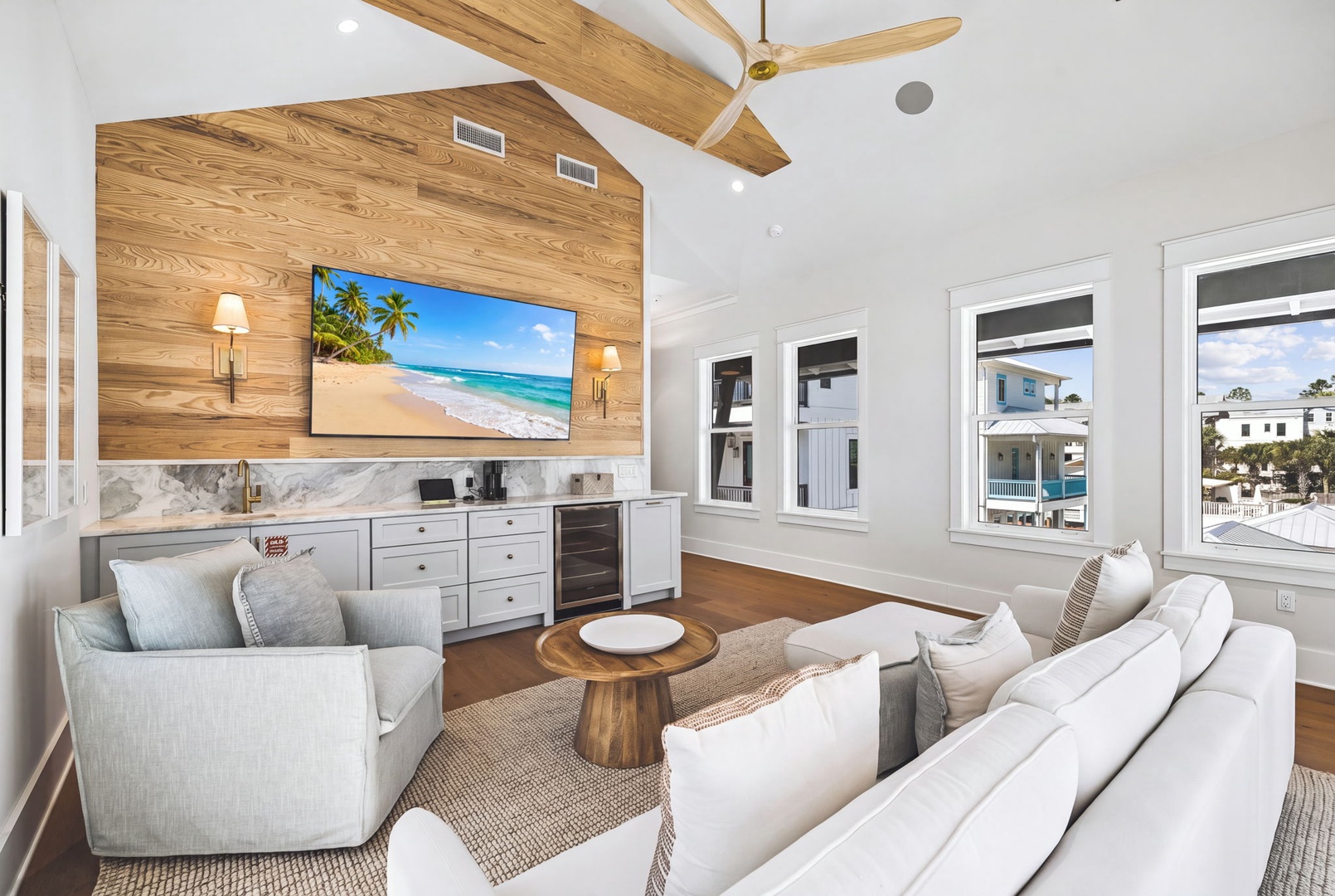Gather in your airy living space with vaulted ceilings, custom woodwork, and a fully equipped kitchenette for effortless entertaining. Large windows frame the surrounding neighborhood and fill the room with natural light.