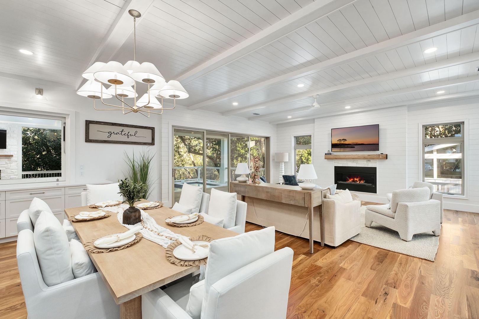 Your open-concept living space blends warm wood with crisp white for perfect relaxation and dining together.