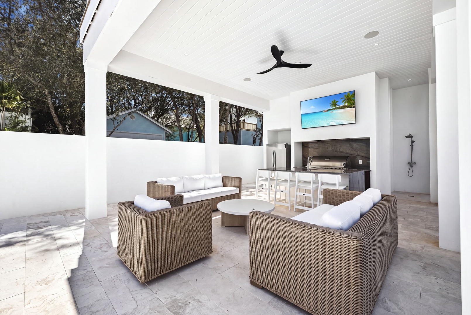 Your private covered patio offers stylish wicker seating, an outdoor dining area, and a built-in grill station—perfect for relaxed evenings and outdoor entertaining.