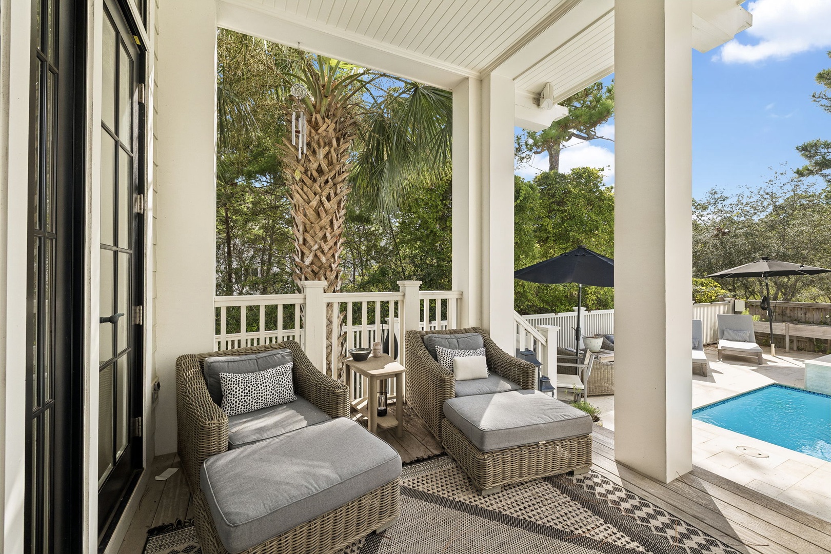 Settle into your private porch with plush loungers and soak in the tranquil garden views. Just beyond, your pool awaits for a refreshing dip under swaying palms.