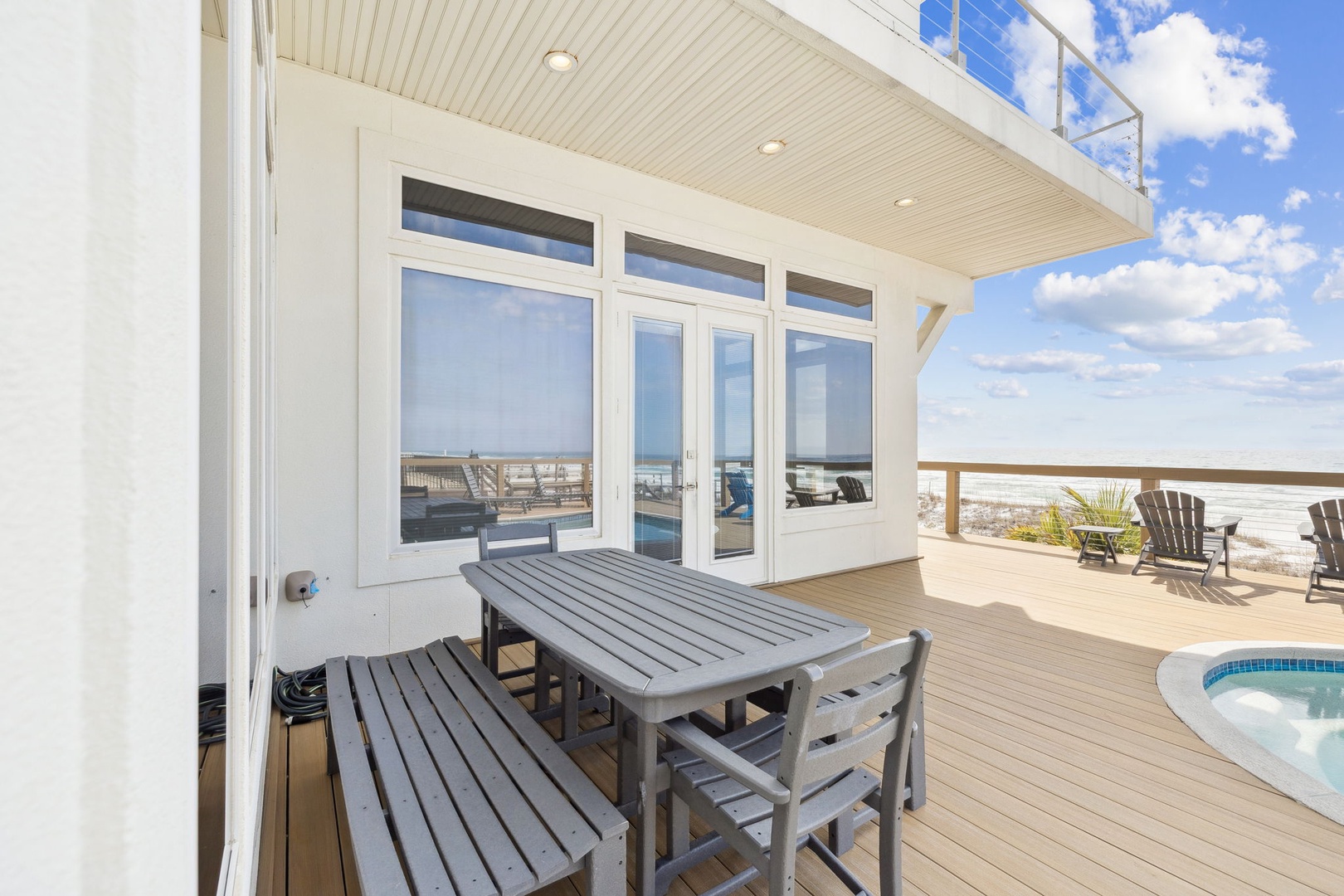 Step onto your private beachfront deck where ocean breezes and endless sea views create the perfect setting for dining al fresco.