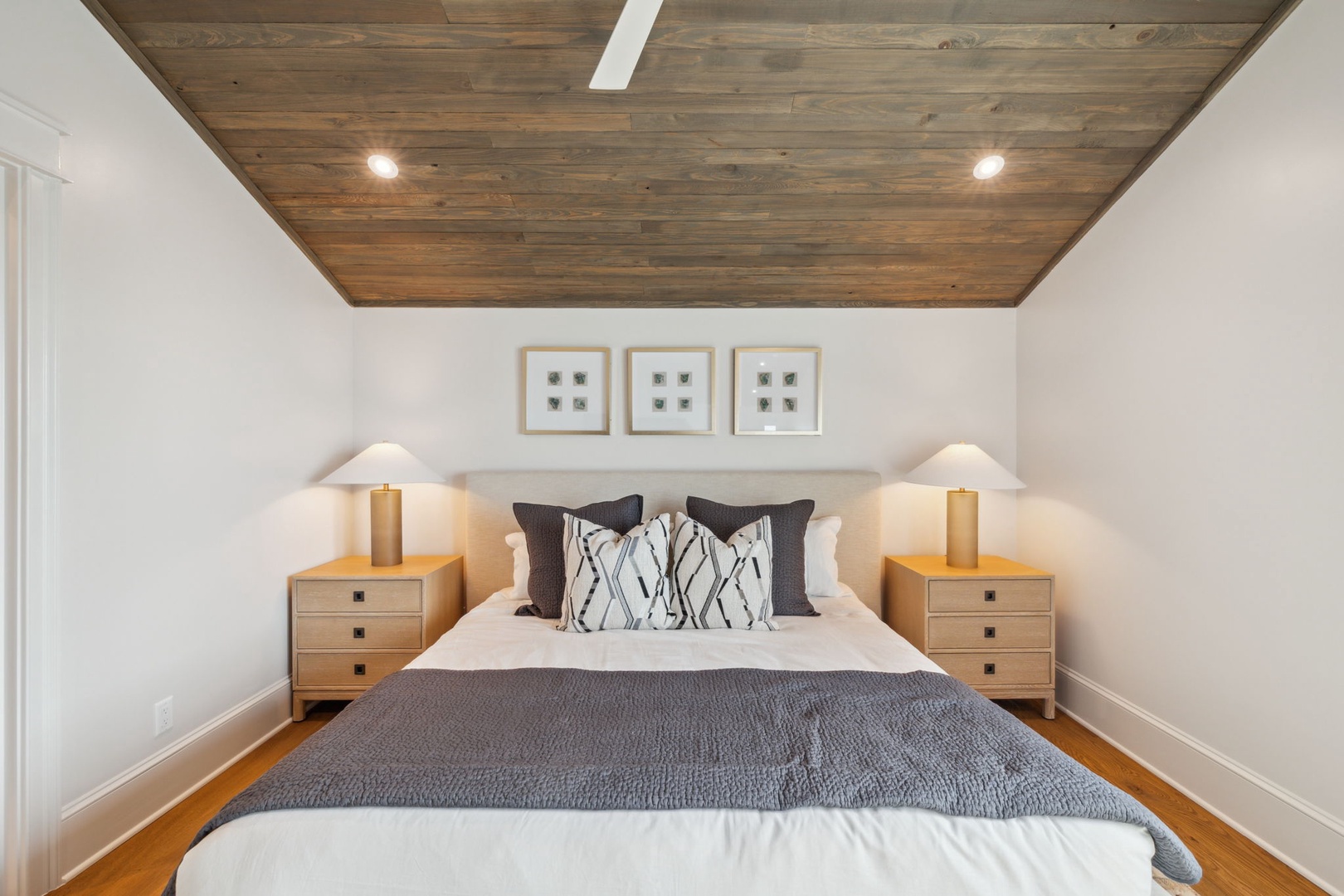 Unwind in your serene bedroom where rustic wood ceilings and soft lighting create a peaceful retreat, inviting you to sink into plush linens and drift away after exploring.