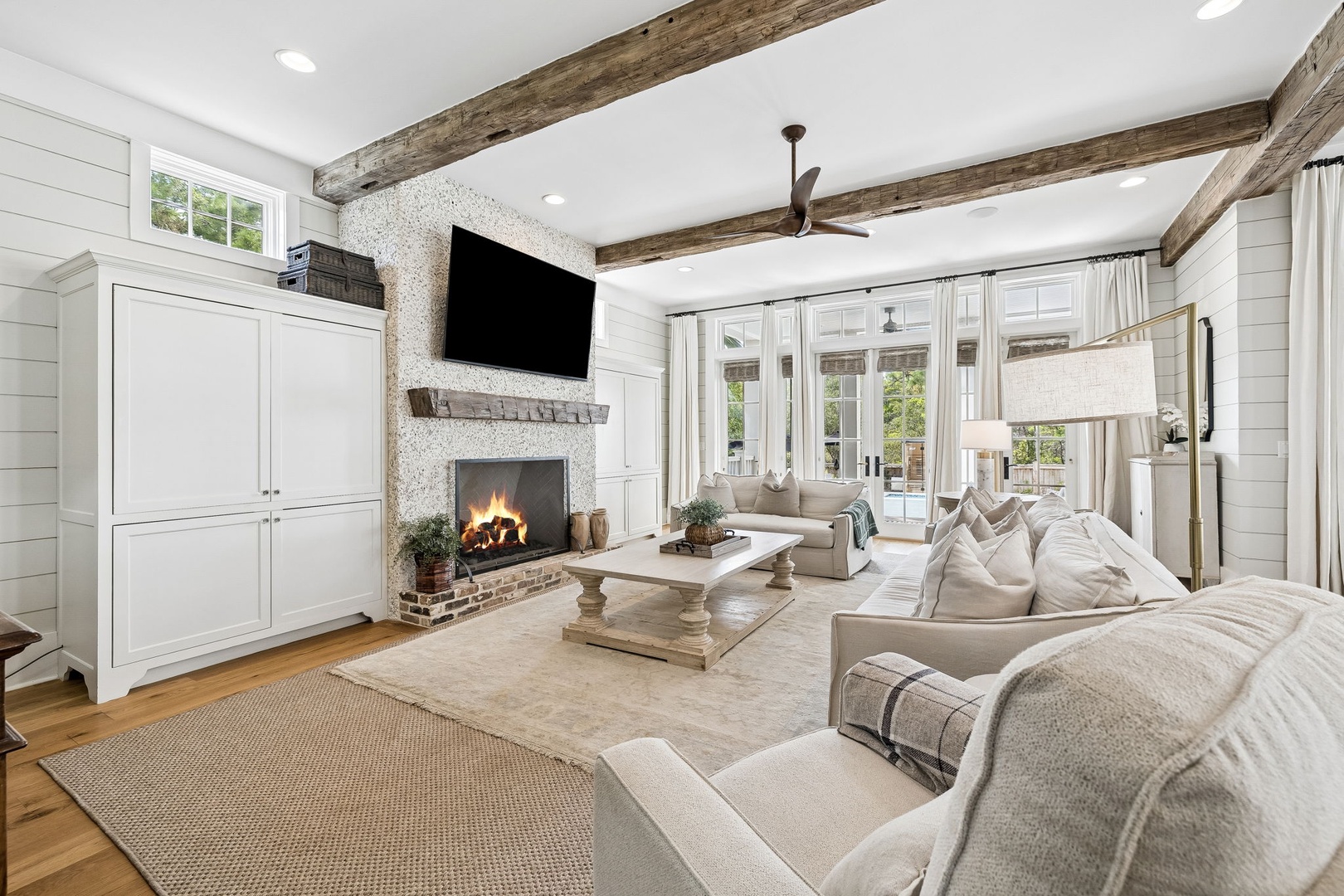 Sink into plush sofas beneath soaring beams as the fireplace crackles softly—your peaceful retreat where rustic charm meets modern comfort.