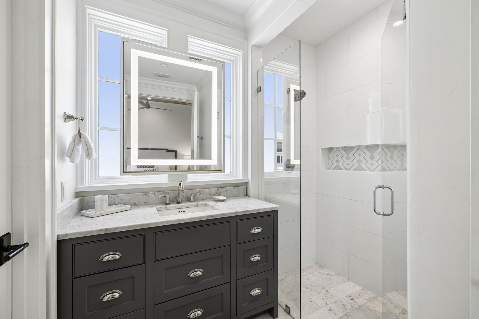 Step into your private spa-like retreat. Gleaming white subway tiles, elegant marble countertops, and a spacious walk-in shower create the perfect space to start and end your day refreshed.