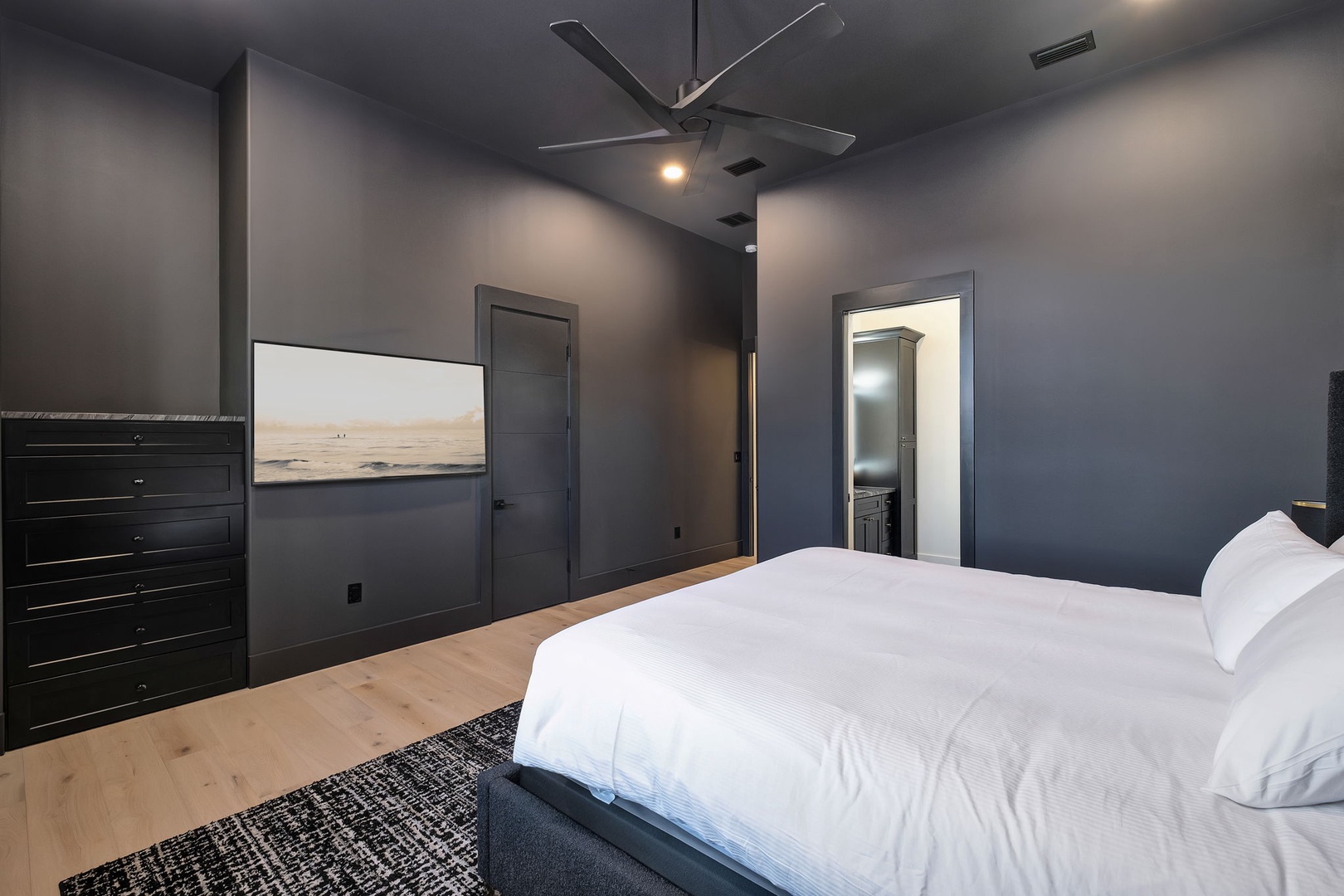 Drift off in your serene master bedroom with plush white linens and modern coastal artwork creating the perfect retreat.