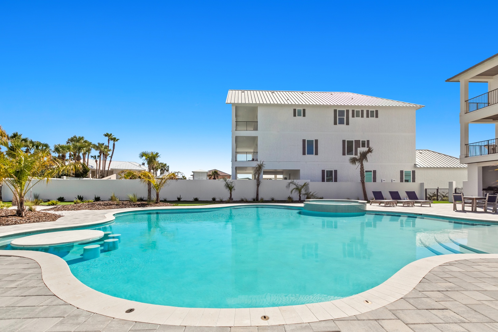 Sparkling turquoise waters invite you to dive into your own private oasis, surrounded by swaying palms and sunny skies—the perfect backdrop for lazy afternoons and sun-soaked relaxation.