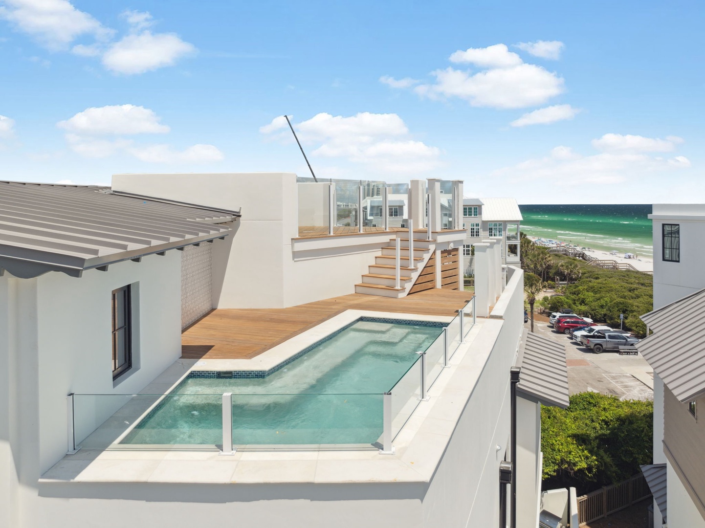 Modern rooftop terrace with sleek pool and stunning ocean views, just steps from the beach. Contemporary design blends seamlessly with coastal surroundings.