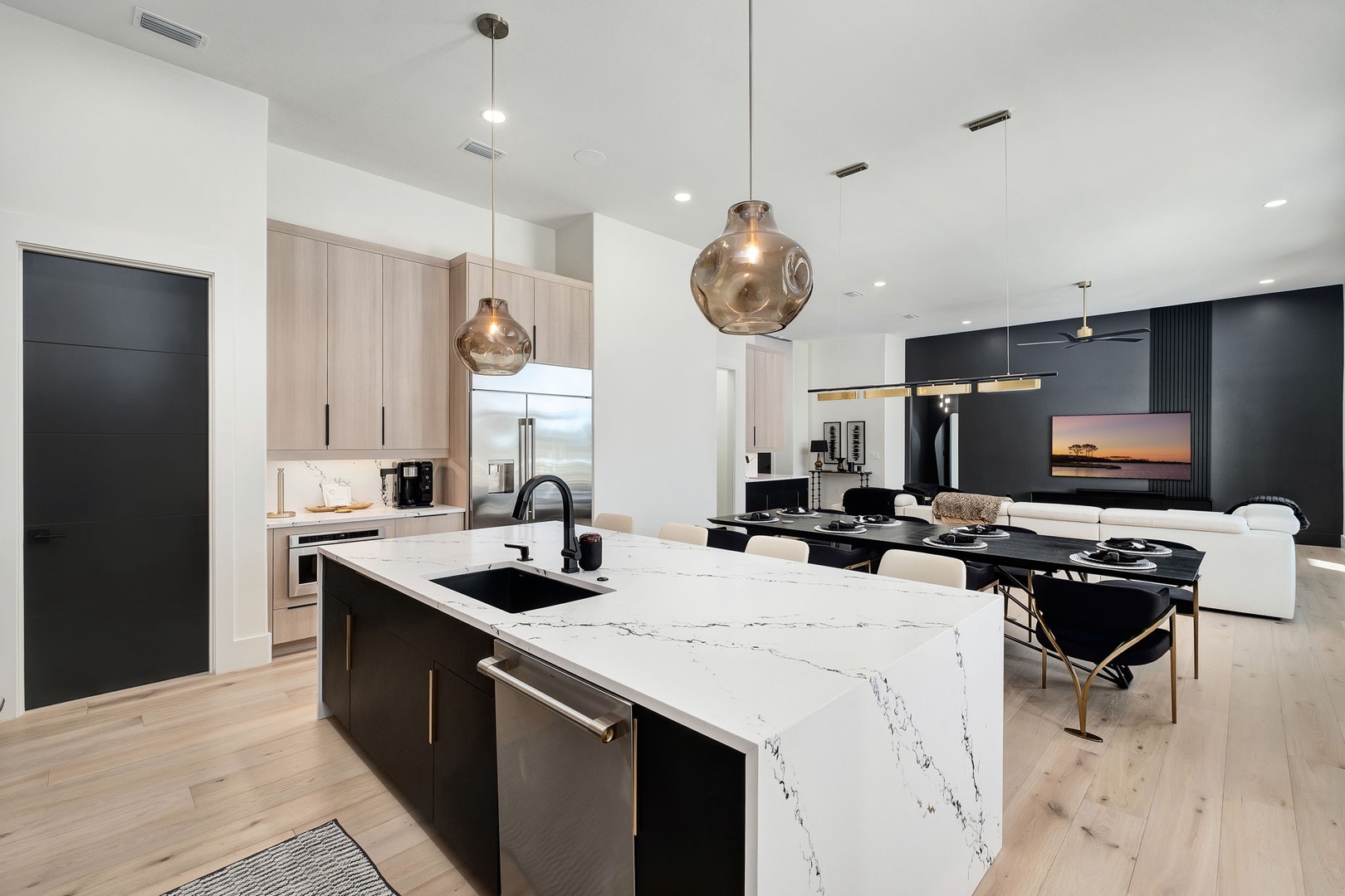 Your modern chef's kitchen features stunning marble countertops, premium appliances, and elegant pendant lighting for memorable meal prep.