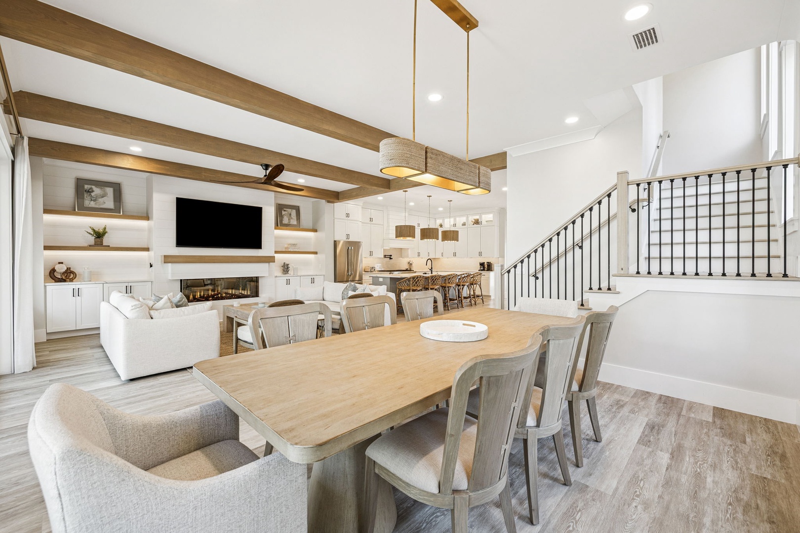 Step into your elegant dining space where wood beams and modern design create the perfect setting for memorable meals with loved ones.