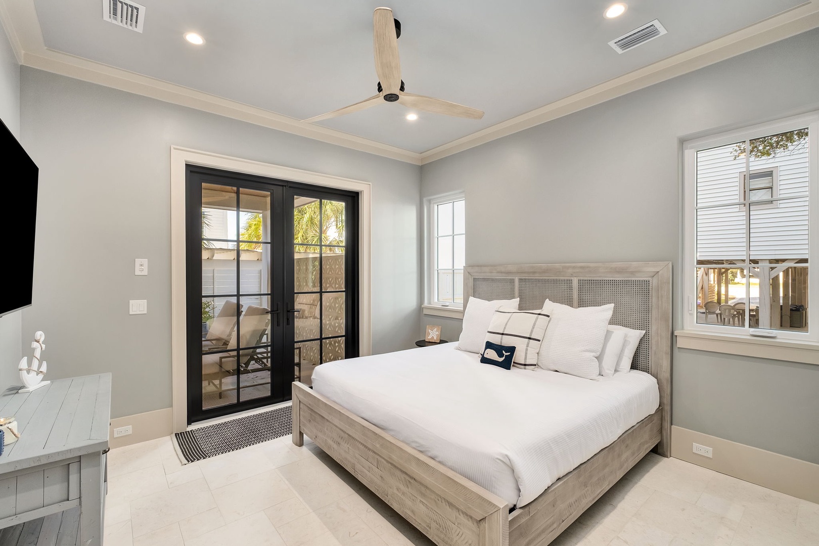 Rest peacefully in your coastal-inspired bedroom with crisp linens and French doors opening to your private outdoor space.