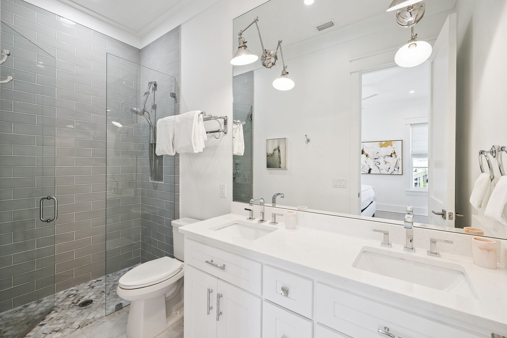 Indulge in your private spa-like retreat with marble countertops, glass shower, and elegant fixtures creating pure relaxation.