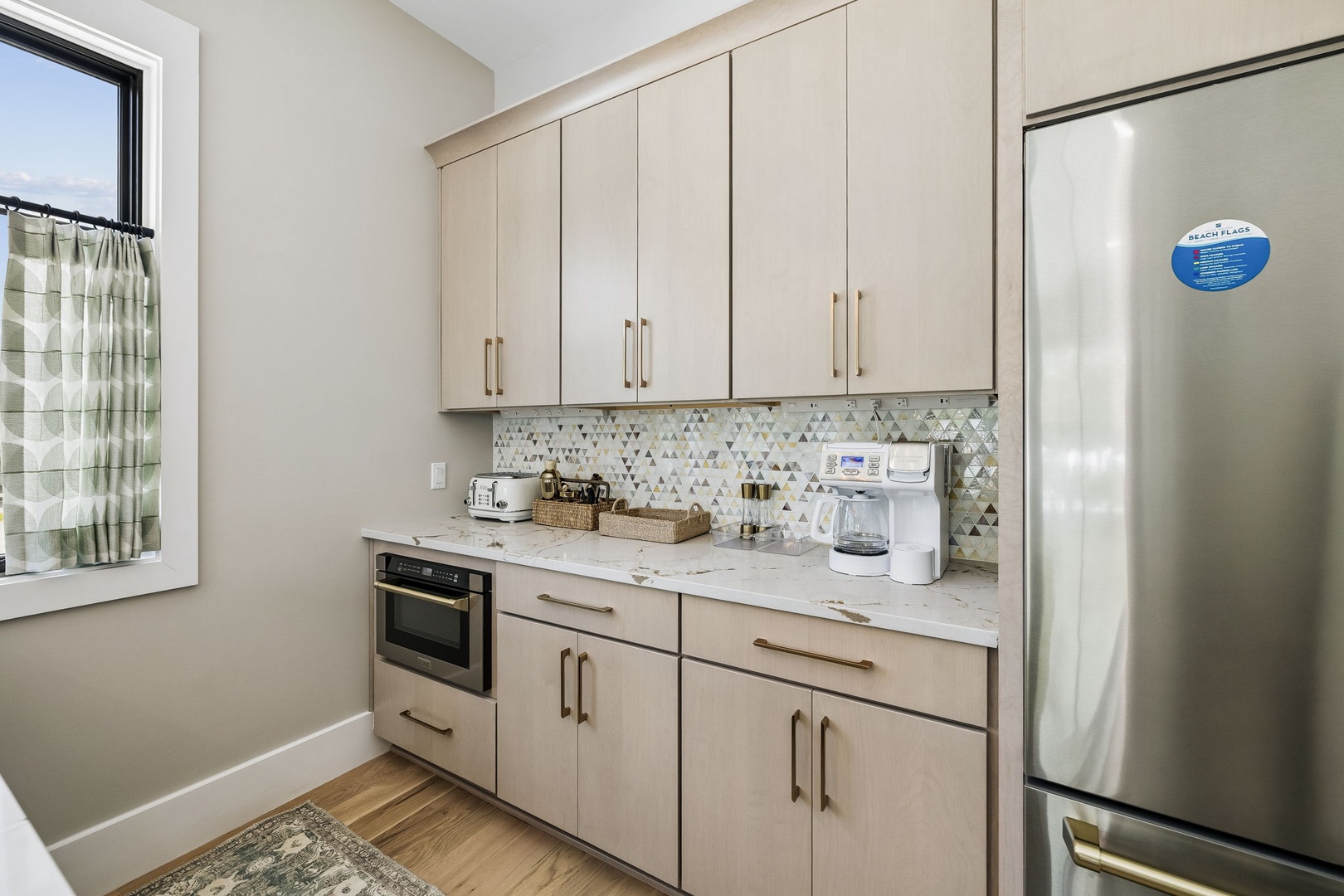Your fully equipped kitchen blends modern design with thoughtful details—warm cabinetry, sleek countertops, and stainless steel appliances await your morning coffee or homemade meals.