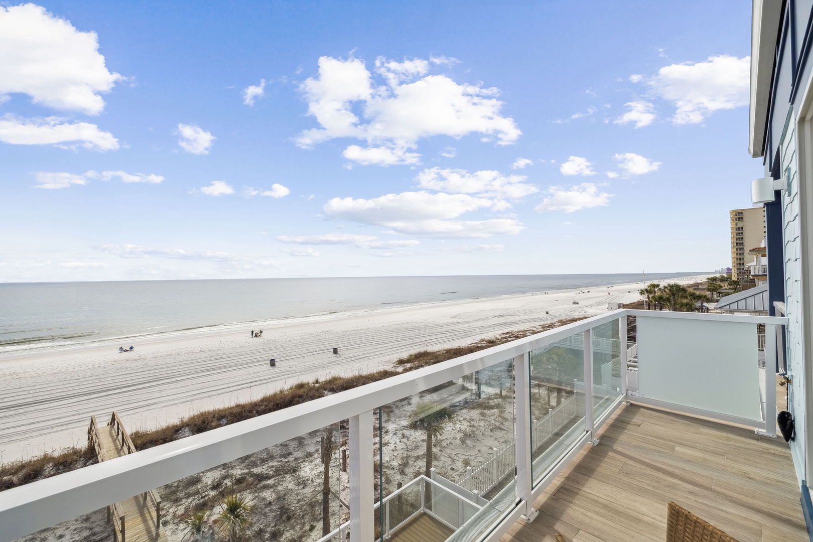 Stunning beachfront balcony with panoramic ocean views and direct beach access from this coastal property.