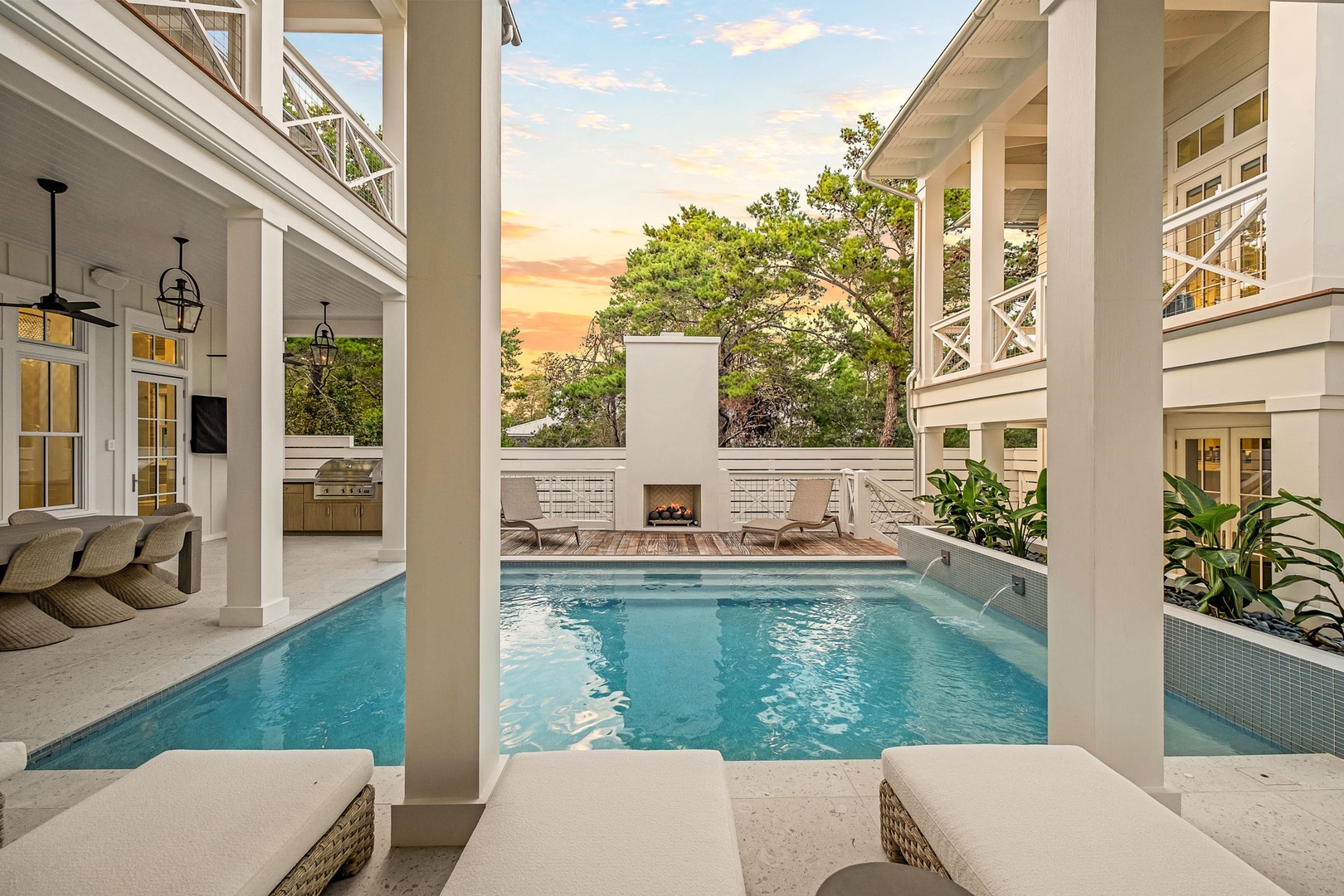 Step into your private courtyard oasis, where a pristine pool beckons beneath a sunset-painted sky. Lounge on cushioned sunbeds, fire up the grill, or cozy up by the outdoor fireplace—your perfect retreat awaits.