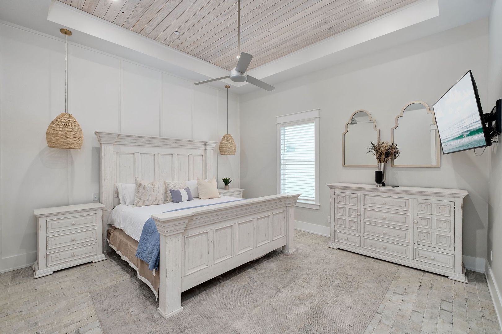 Sink into your coastal sanctuary featuring a king bed, whitewashed wood ceiling, and calming neutral tones for ultimate relaxation.
