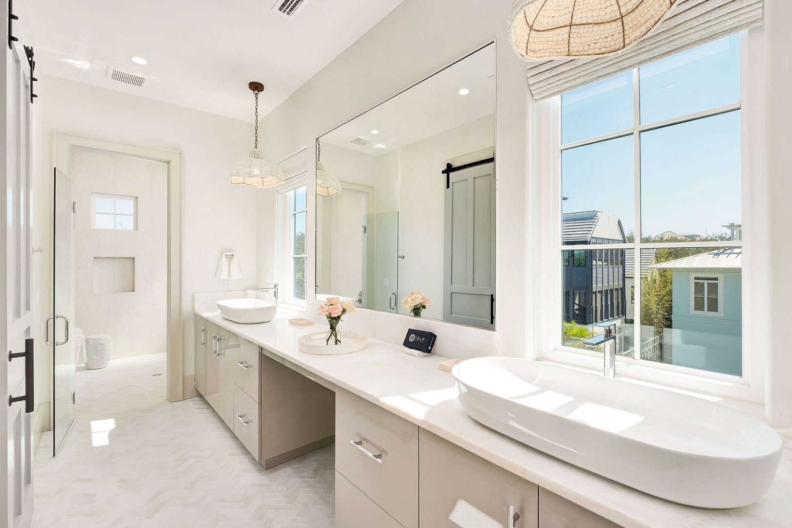 Pamper yourself in this stunning spa-like bathroom with dual vanities, marble countertops, and abundant natural light streaming through oversized windows.