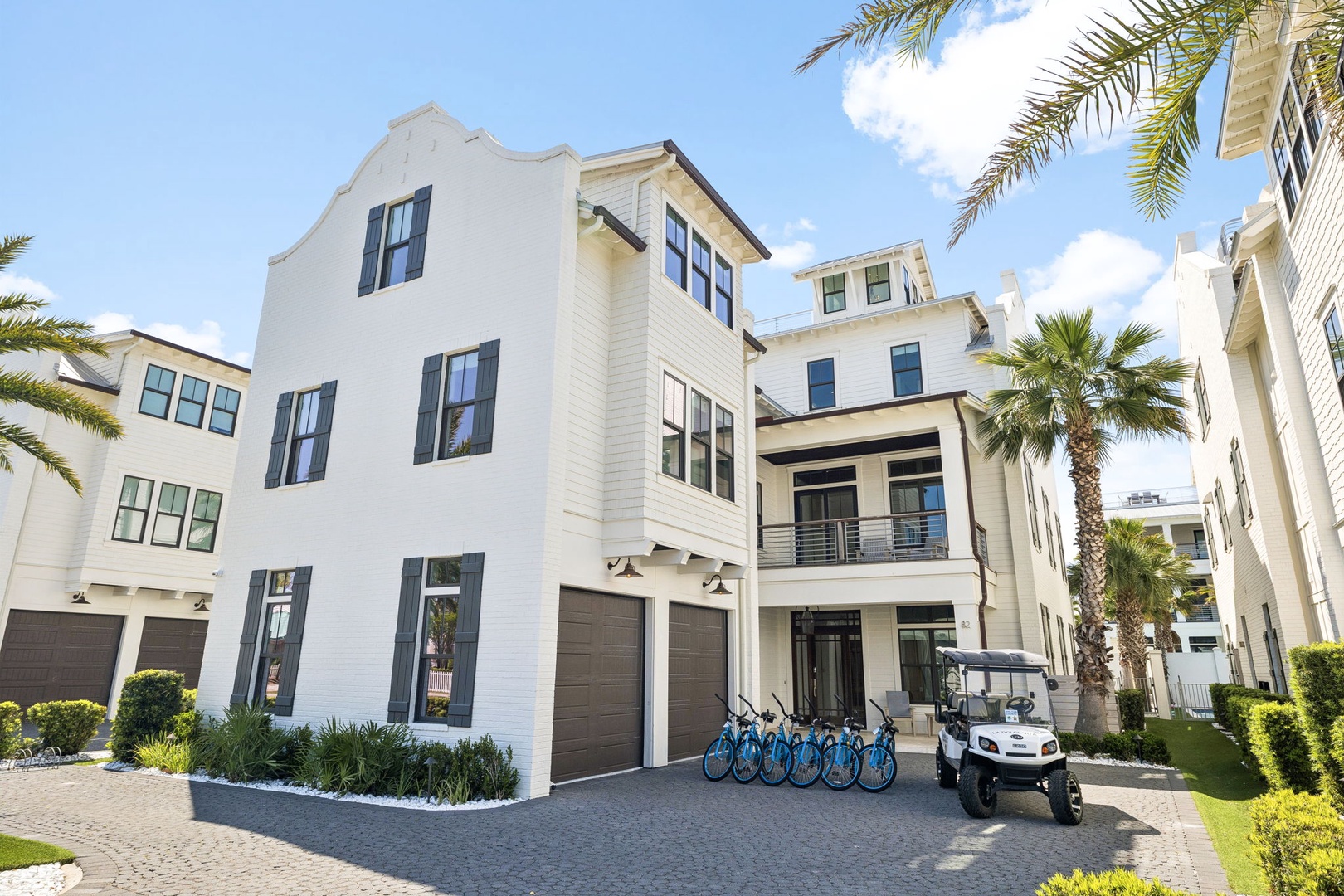 Modern coastal architecture with palm trees creates an inviting neighborhood setting for your tropical getaway.