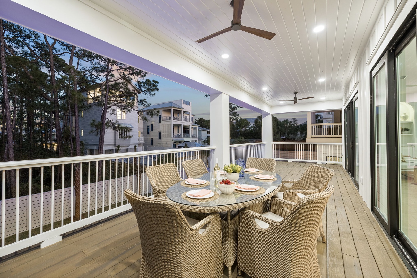 Your spacious covered deck invites memorable meals with wicker dining for six, ceiling fans for comfort, and peaceful neighborhood views.