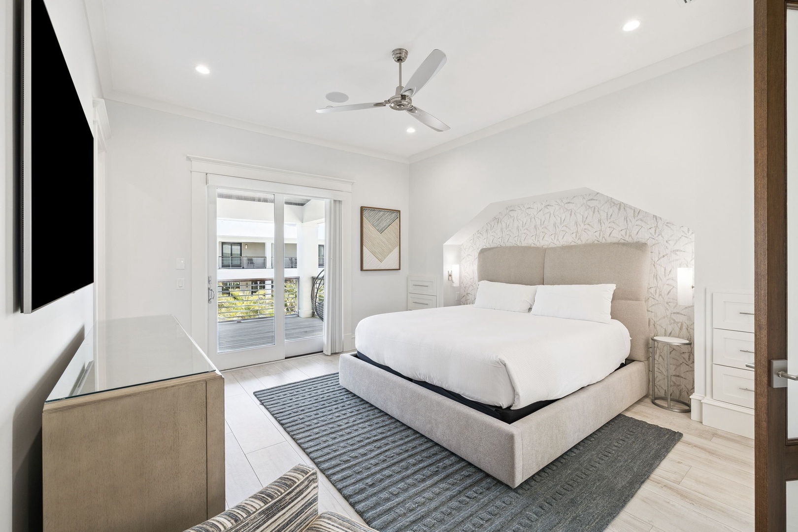 Your elegant bedroom features crisp white linens and modern furnishings, creating a peaceful sanctuary for restful nights.