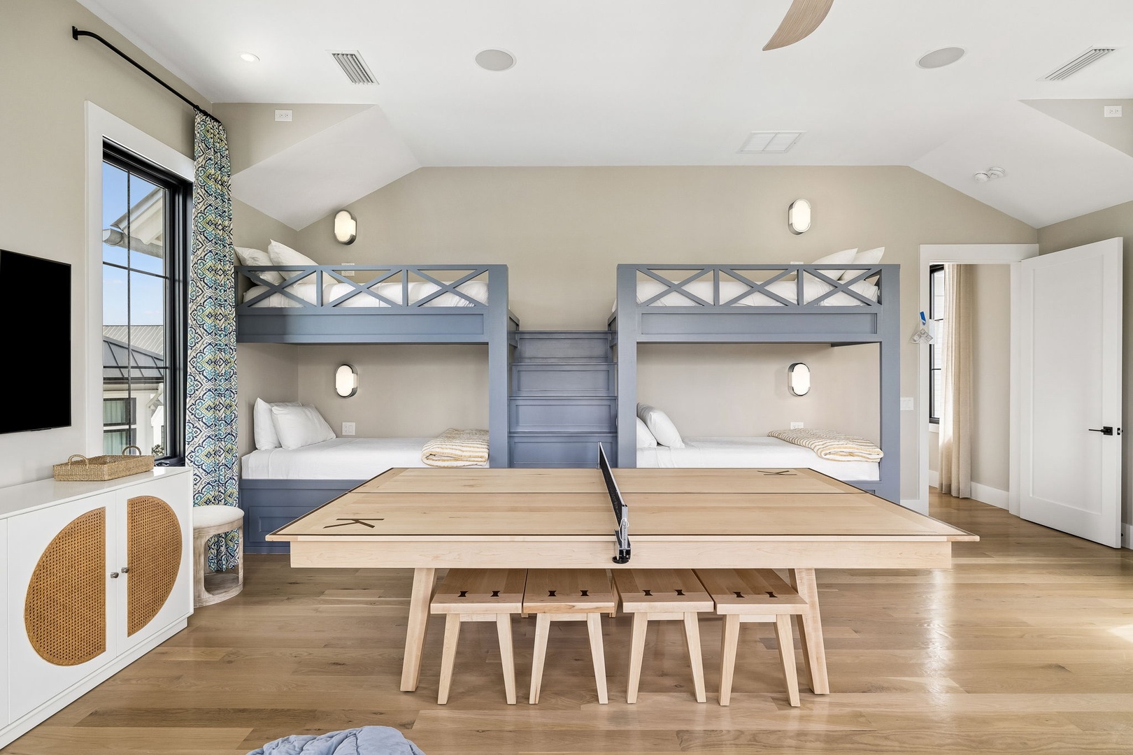 Gather with your group around the custom table, enjoy games or meals, then retreat to your cozy built-in bunks for a peaceful night's rest in this bright, stylish space.