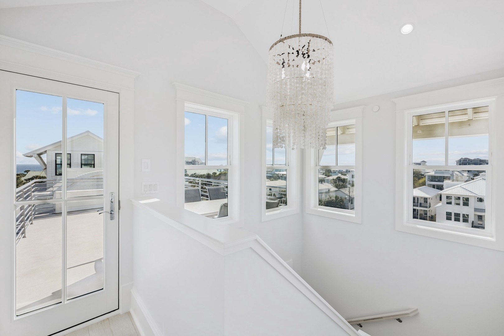 Sunlight streams through expansive windows in your bright, airy space, while an elegant chandelier adds sparkle to moments of relaxation.