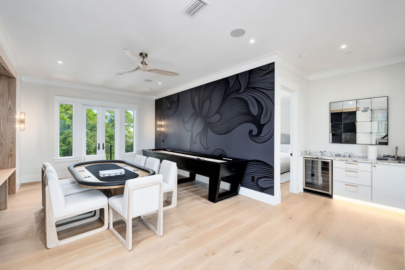 Your private game room blends sleek style with comfort—gather friends around the poker table or challenge them to billiards, then refresh at your kitchenette with chilled drinks and scenic views.