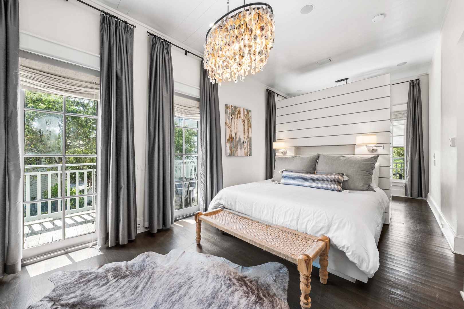 Drift off beneath the sparkling chandelier in your elegant bedroom, where crisp linens and stylish décor create the perfect retreat.