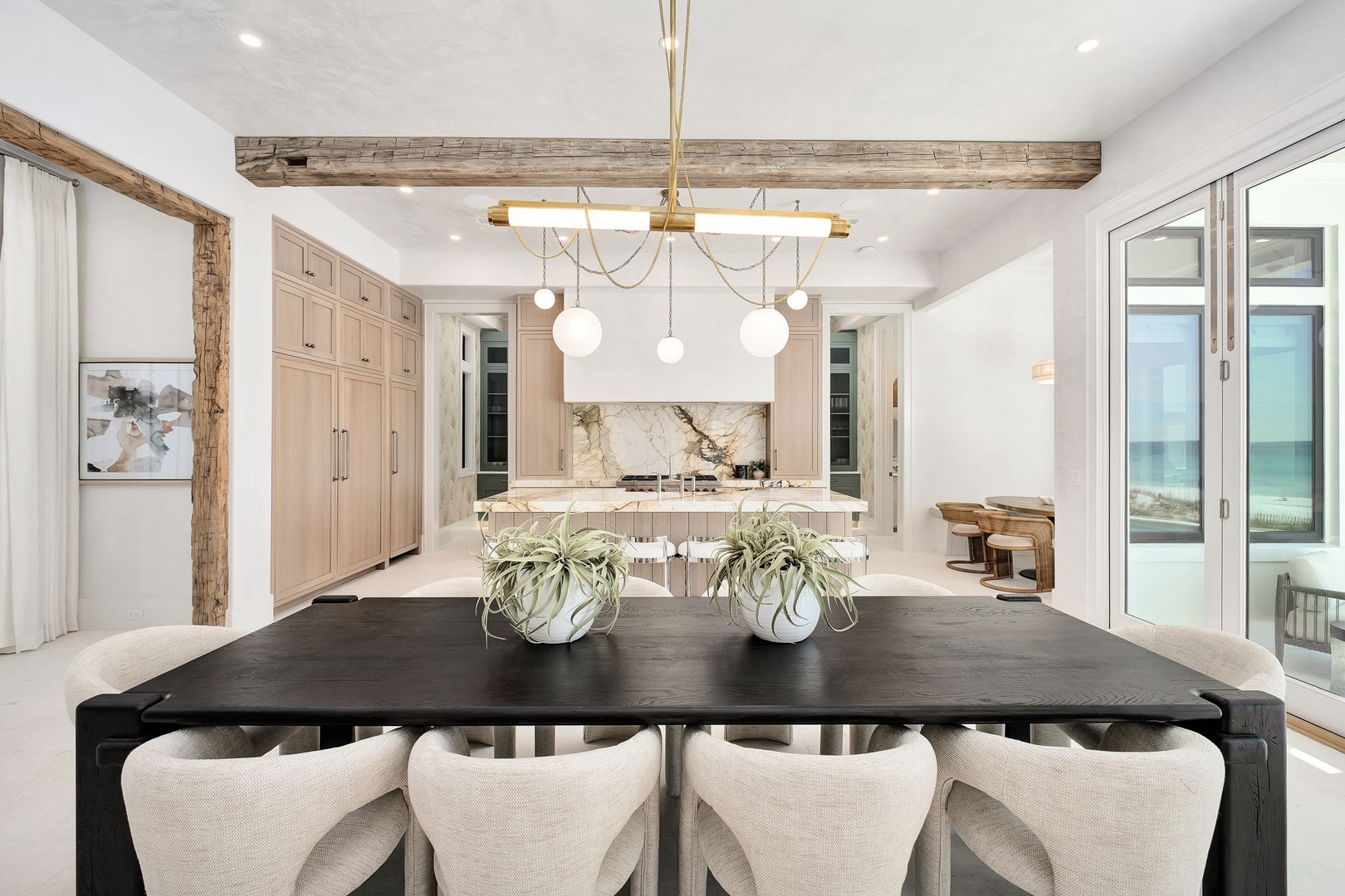 Your elegant dining space flows seamlessly into a stunning kitchen, perfect for memorable meals with ocean breezes.