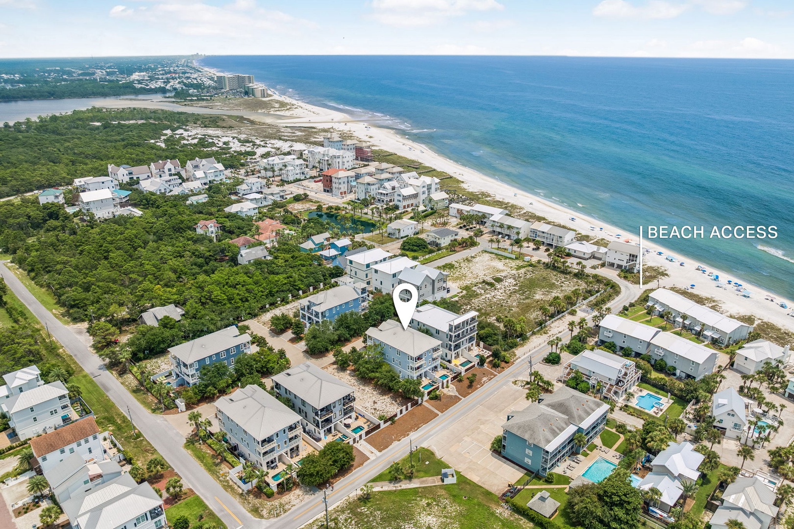 Aerial view showcasing the property's prime beachfront location within a quiet residential community, with direct access to pristine white sand shores.