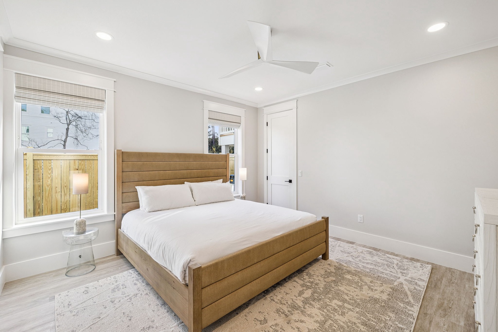 Drift off to dreamland in your serene bedroom, where crisp linens and warm wood tones create the perfect peaceful retreat.