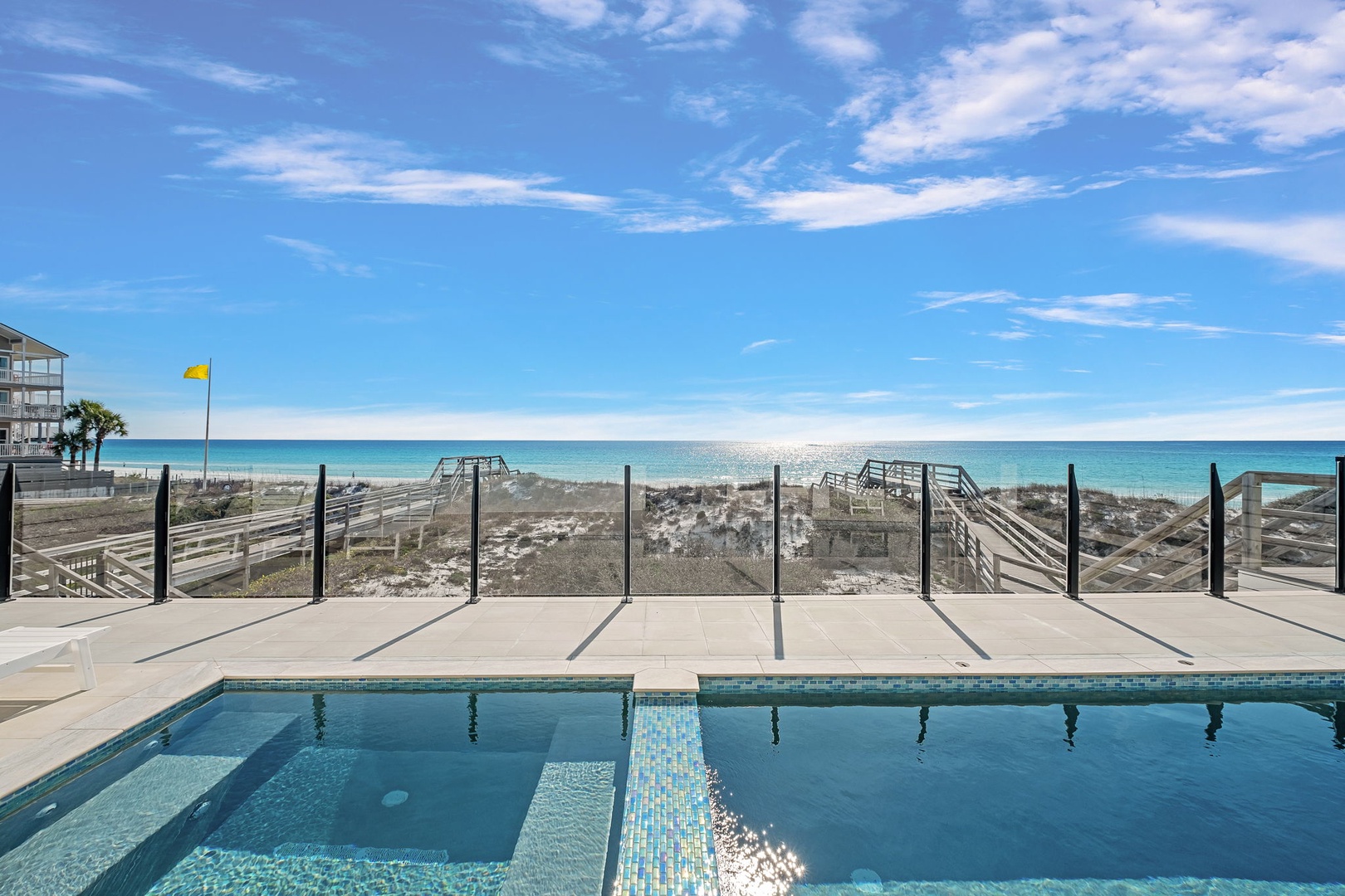 Stunning beachfront pool with direct ocean access and pristine white sand views.