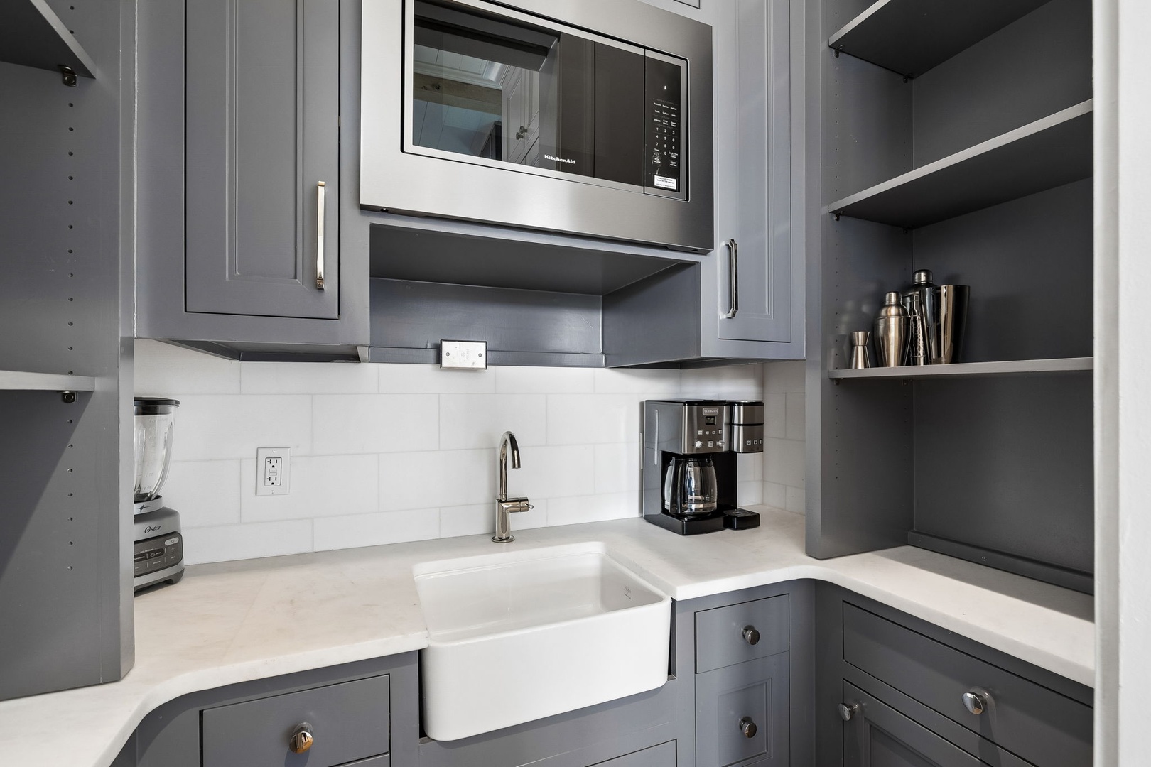 Your modern kitchen features a deep farmhouse sink, sleek stainless appliances, and everything you need to whip up your favorite meals. Fresh coffee awaits in the morning.