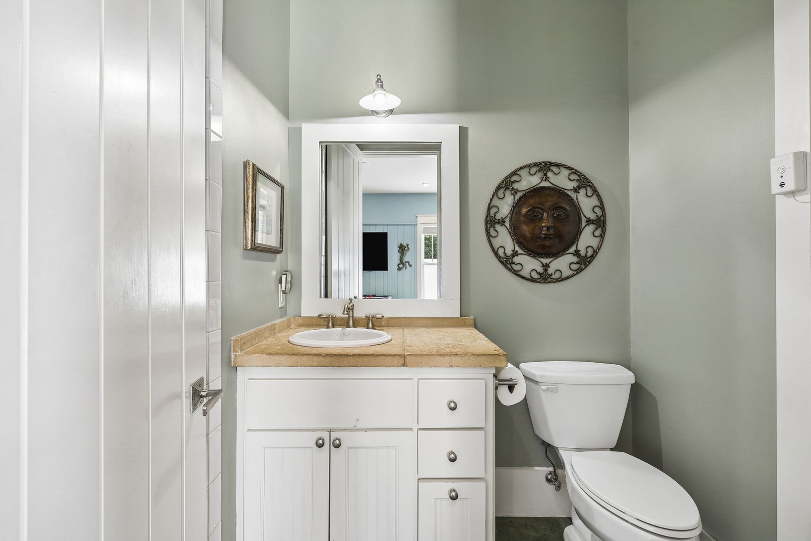 Step into your serene bathroom where soft sage walls and warm wood tones create a calming retreat. The charming vanity and distinctive decor add character to your private space.