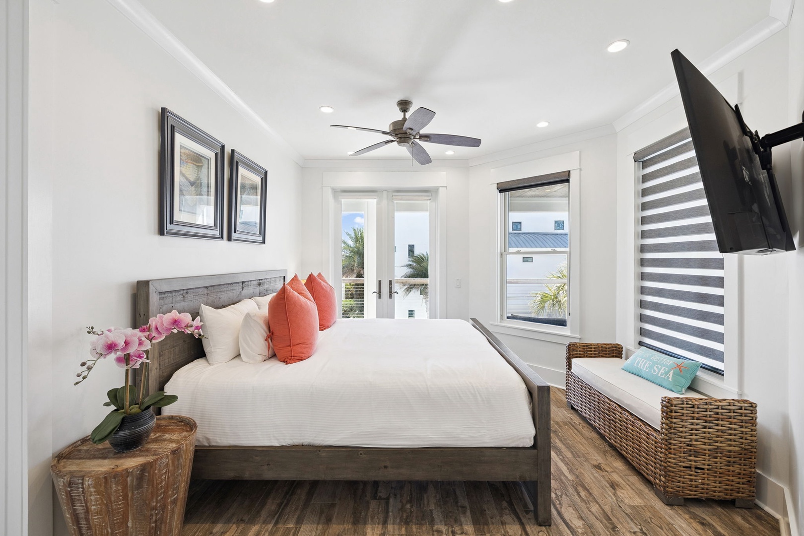 Unwind in your bright coastal bedroom with crisp linens, warm wood accents, and peaceful tropical touches that invite restful nights.