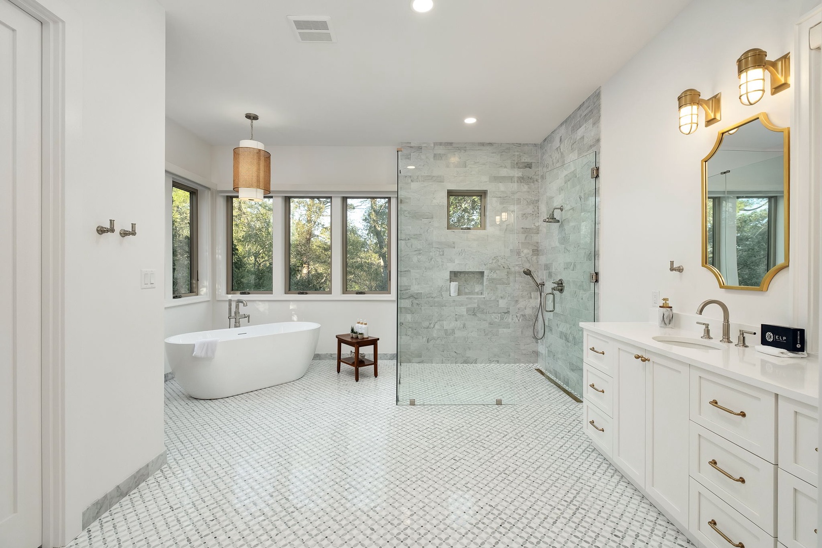 Soak in your luxurious freestanding tub while natural light streams through large windows, creating the perfect spa-like retreat for unwinding.