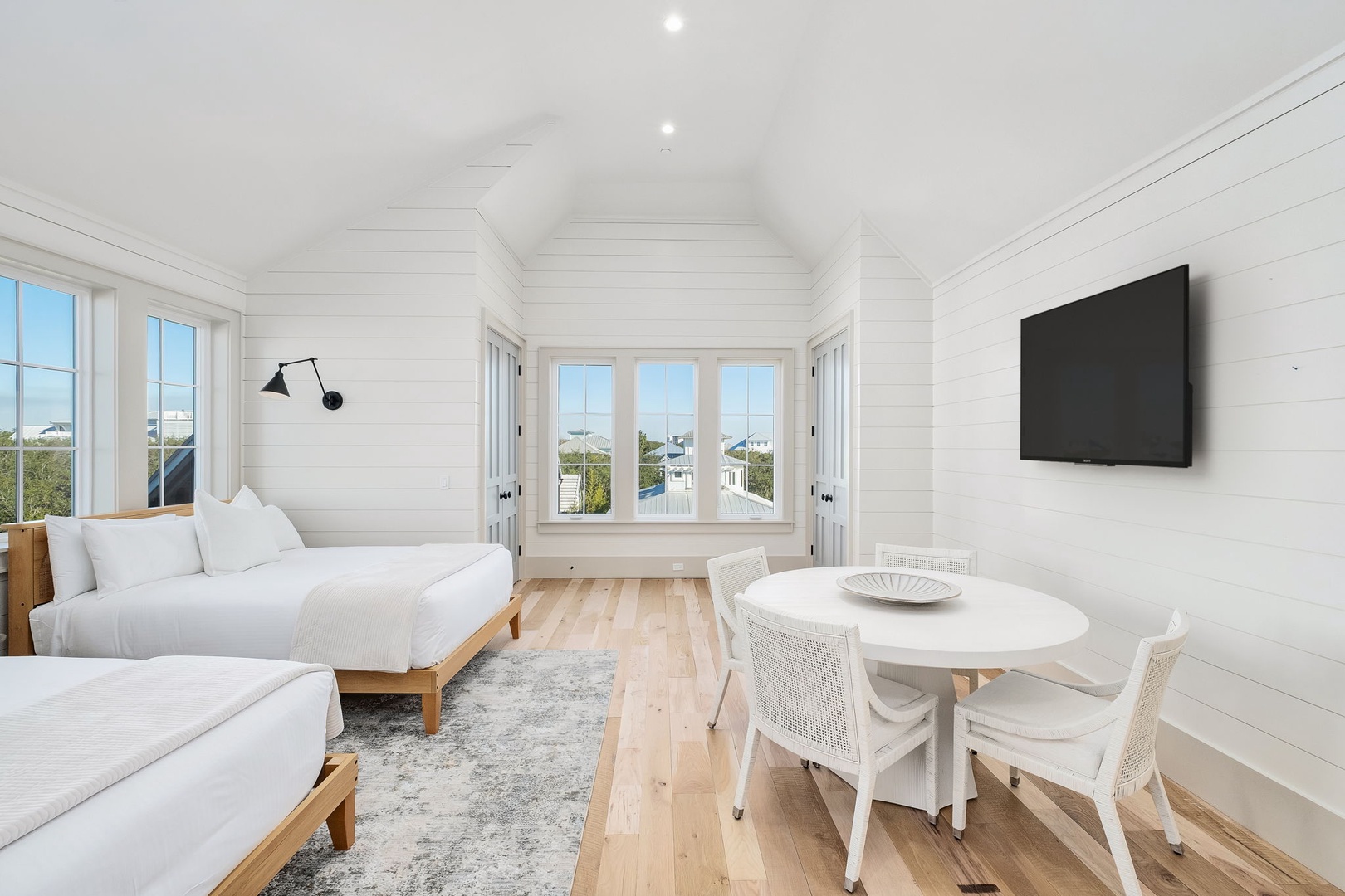 Your bright coastal retreat features twin beds, dining nook, and stunning views through oversized windows—perfect for morning coffee.