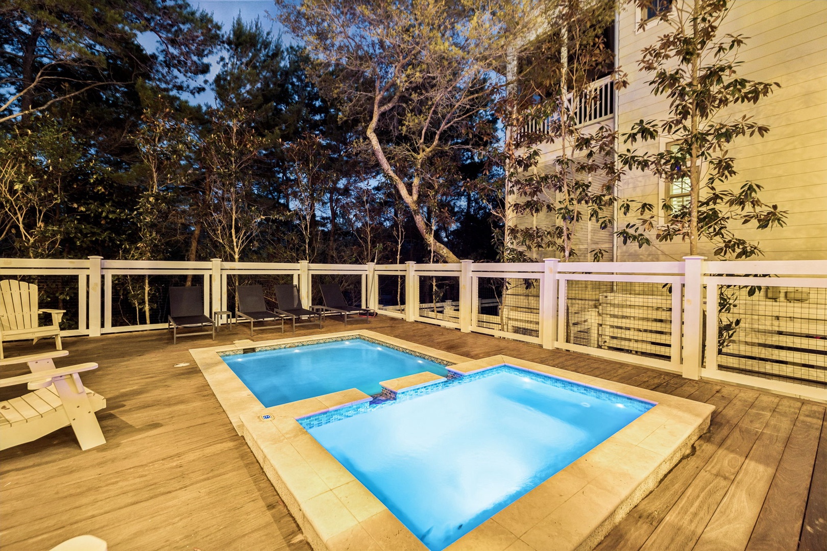 Unwind in your private pool and hot tub, surrounded by towering trees on this peaceful wooden deck retreat.