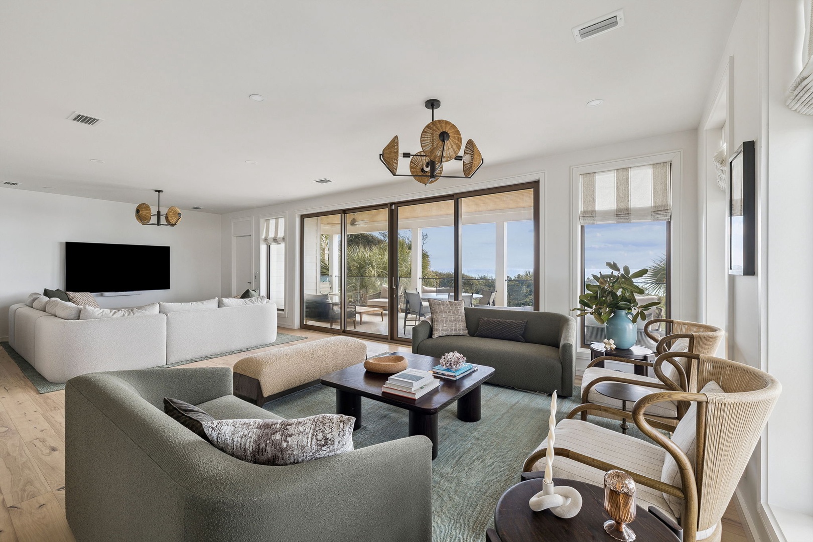 Sink into plush seating while natural light streams through floor-to-ceiling windows, creating your perfect retreat for relaxation and connection.