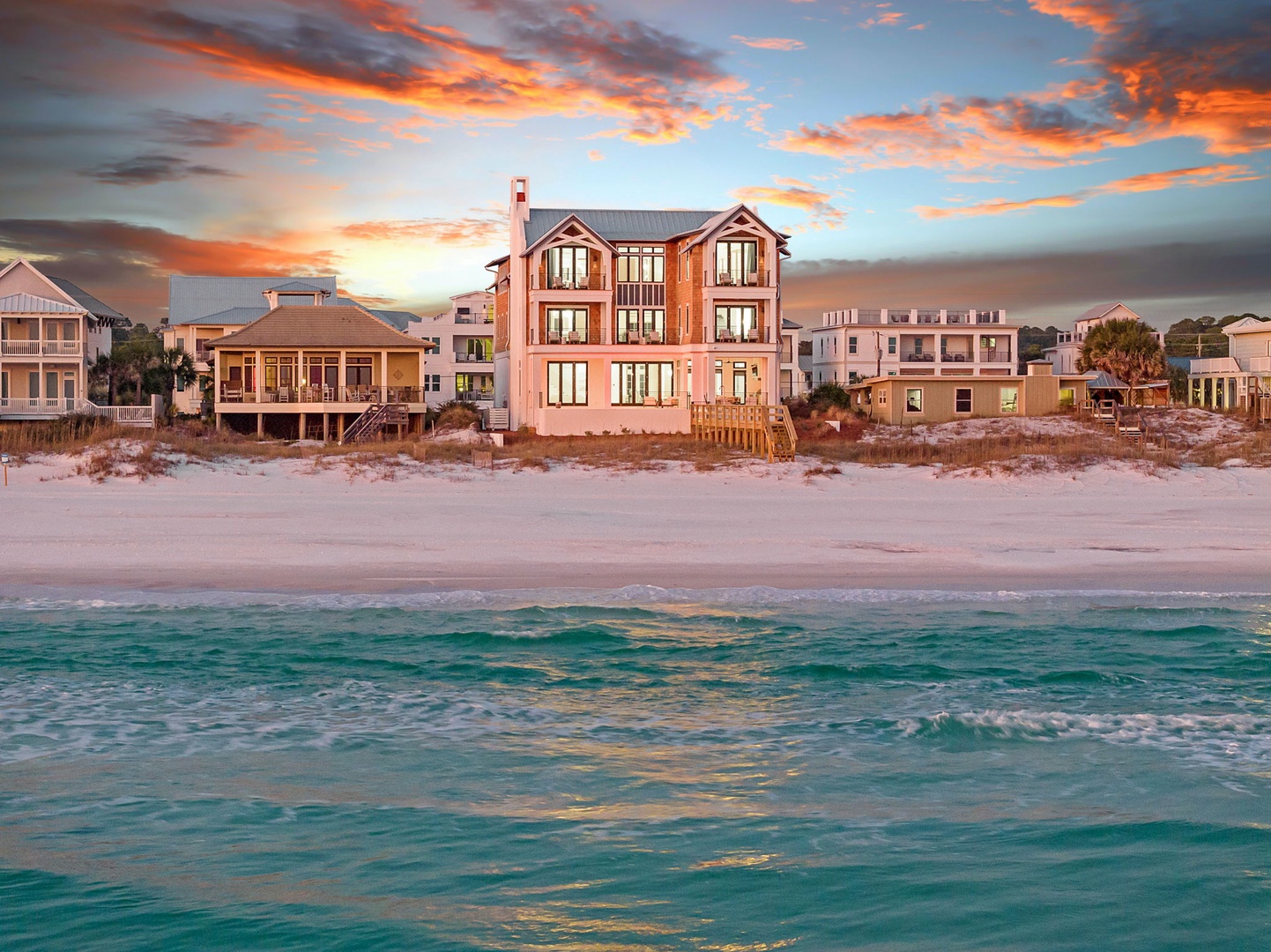 Spectacular beachfront property showcasing dramatic sunset views over pristine white sand and emerald waters in this coastal paradise.